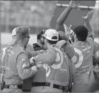  ?? AP/PAUL SANCYA ?? Members of Kyle Larson’s pit crew celebrate after their driver won the Pure Michigan 400 on Sunday at Michigan Internatio­nal Speedway in Brooklyn, Mich. Larson defeated Martin Truex Jr. by 0.310 seconds.