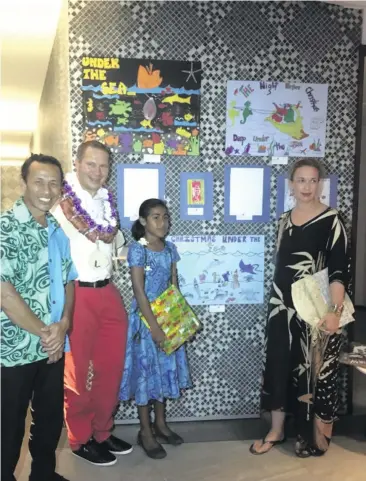  ?? Photo: Lusiana Banuve. ?? Fiji Marriott Resort Momi Bay’s general manager Silvano Dressino and his wife Katarin with art competitio­n entrant Maria and her dad at the Resort.