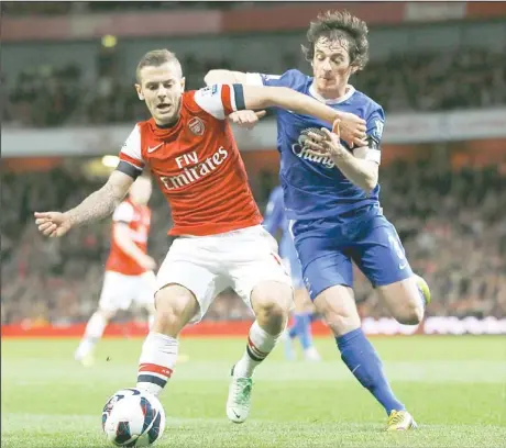  ??  ?? Arsenal’s Jack Wilshere (left), vies for the ball with Everton’s Leighton Baines during the English Premier League soccer match between Arsenal and Everton atthe Emirates Stadium in London on April 16. (AP)