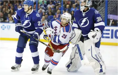  ??  ?? TAMPA: Martin St. Louis No. 26 of the New York Rangers is squeezed between two players in this file photo. — AFP
