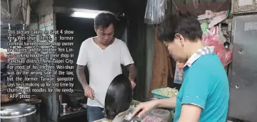  ??  ?? This picture taken on Sept 4 show Yen Wei-shun (left), a former criminal turned noodle shop owner for charity, and his mother Yen Linyin cooking noodles at their shop in Panchiao district, New Taipei City. For most of his life Yen Wei-shun was on the wrong side of the law, but the former Taiwan gangster says he is making up for lost time by churning out noodles for the needy. - AFP photo