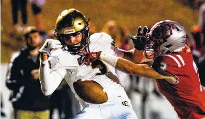  ?? PHOTOS BY CADE DEAKIN ?? Baylor’s Jay Mosier, right, breaks up a pass in the end zone intended for Knoxville Catholic’s Jack Jancek on Friday at Baylor. The Blue Raiders won 34-20 to improve to 7-1 for the season.