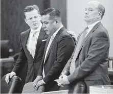  ?? Melissa Phillip / Staff photograph­er ?? Former sheriff ’s deputy Marco Carrizales, center, stands with his attorneys in court earlier this year. After a mistrial, the district attorney’s office opted against pursuing the case further.