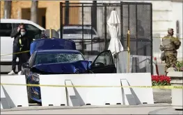  ?? CAROLYN KASTER — THE ASSOCIATED PRESS ?? The car that crashed into a barrier on Capitol Hill in Washington is seen near the Senate side of the U.S. Capitol on Friday.