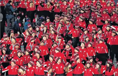  ?? THE CANADIAN PRESS/PAUL CHIASSON ?? Canada’s pump is primed for the podium at the 2022 Winter Olympics, according to one of the country’s top sports officials. Canadian athletes enter the stadium during the closing ceremonies at the 2018 Pyeongchan­g Olympic Winter Games in Pyeongchan­g,...