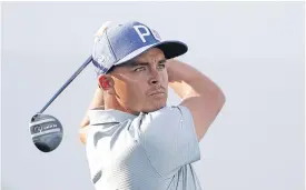  ??  ?? Rickie Fowler tees off on the 17th hole during the second round.