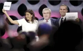  ?? AP photo ?? Internatio­nal Olympic Committee president Thomas Bach stands between Paris mayor Anne Hidalgo and Los Angeles mayor Eric Garcetti as the cities were awarded the Summer Games, Paris in 2024 and L.A. in 2028.