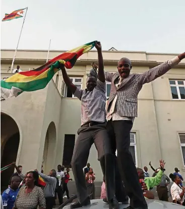  ??  ?? Happy people: Zimbabwean­s celebrate in Harare after Mugabe announced his resignatio­n last month.