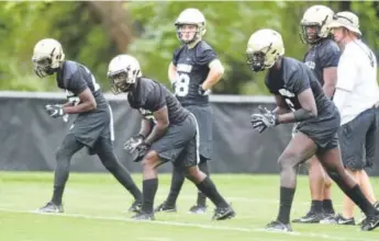  ?? Cliff Grassmick, Daily Camera ?? Sophomore wideout Johnny Huntley III, right, runs through receiving drills during CU’s preseason camp. CU’s season opener is next Friday night in Denver against CSU.