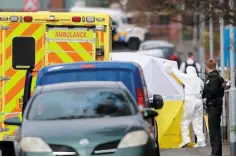  ??  ?? Maeve Sheehan
ARDOYNE: Police officers at the scene of yesterday’s shooting