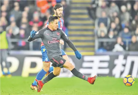  ?? — AFP photo ?? Arsenal’s Chilean striker Alexis Sanchez shoots and scores their third goal during the English Premier League football match between Crystal Palace and Arsenal at Selhurst Park in south London on December 28, 2017.