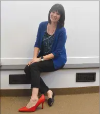  ?? NEWS PHOTO MO CRANKER ?? SARC executive director Christina Johnson poses for a photo at her downtown office Monday afternoon with a size-12 men's high-heel shoe. One June 3, a group of men will be walking one mile in a pair of heels to raise awareness of gender-based violence.