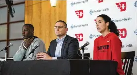  ?? AARON DOSTER / ASSOCIATED PRESS ?? Dayton women’s basketball coach Shauna Green (right) appears at a press conference Friday with Director of Athletics Neil Sullivan (center) and men’s coach Anthony Grant. They took turns answering questions about their teams’ disappoint­ment in having their seasons cut short by the coronaviru­s pandemic.