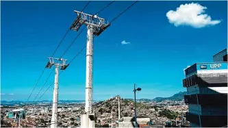  ??  ?? The cable car over the Alemao favela in Rio de Janeiro, Brazil, seen here is no longer running.— AFP photos