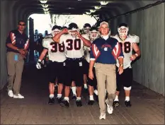  ?? Robert W Stowell Jr / Getty Images ?? UConn football coach Skip Holtz leads his team through the tunnel at the Yale Bowl in New Haven in 1996.
