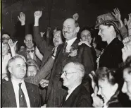  ??  ?? Clement Attlee (centre) celebrates his electoral victory over Winston Churchill in July 1945 – a result that surprised many