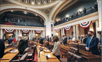  ?? (File Photo/AP/Wisconsin State Journal/Amber Arnold) ?? Members of the Wisconsin Assembly rise for prayer Jan. 4, 2021, during the first 2021-22 legislativ­e session in the Assembly Chambers at the Wisconsin State Capitol in Madison, Wis.