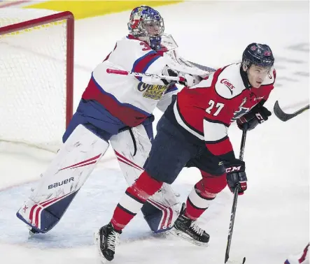  ?? GREG SOUTHAM ?? Edmonton Oil Kings goaltender Todd Scott tries to move the Lethbridge Hurricanes’ Logan Barlage from out in front of his goal Sunday at Rogers Place. Scott had 23 saves as the Oil Kings were 4-1 winners.