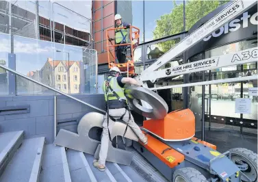  ?? Photograph: Ben Birchall ?? Contractor­s removing the name from outside Colston Hall in June this year