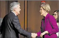  ?? AP/CAROLYN KASTER ?? Sen. Elizabeth Warren, D.-Mass., greets Jerome Powell, President Donald Trump’s nominee for chairman of the Federal Reserve Board, before he testifies at a committee confirmati­on hearing Tuesday.