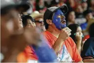  ??  ?? A true-blue Astros fan takes in the action at Fenway Park from his seat some 1,600 miles away at Minute Maid.