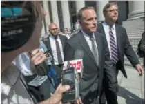  ?? MARY ALTAFFER — THE ASSOCIATED PRESS ?? Republican U.S. Rep. Christophe­r Collins, center, leaves federal court, Wednesday in New York. Rep. Collins of western New York state has been indicted on charges that he used inside informatio­n about a biotechnol­ogy company to make illicit stock trades