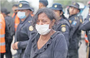  ?? [AP PHOTO] ?? A resident cries after she was safely evacuated from her home Monday near the Volcan de Fuego, or “Volcano of Fire,” in Escuintla, Guatemala.