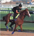  ??  ?? Exercise rider Humberto Gomez rode Triple Crown hopeful Justify during a workout on Memorial Day at Churchill Downs.