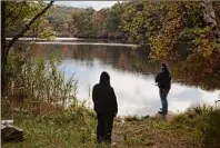  ?? Susan Stava / New York Times ?? People fish in Harriman State Park. There are disputes about how the NYC Chapter of the Adirondack Mountain Club is maintainin­g Camp Nawakwa, a retreat in the park.