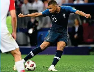  ?? AFP ?? Power play: Mbappe’s muscles bulge as he fires France’s fourth