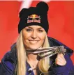  ?? Christophe Pallot / Getty Images ?? Vonn displays the bronze medal she won in the women’s downhill in Are.