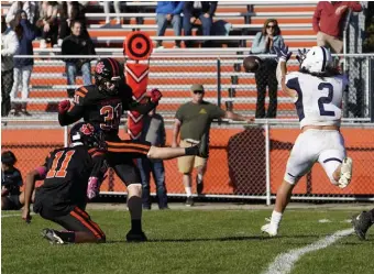  ?? MARY sCHwALm / bostoN HeRALD ?? SAVING A WIN: Xaviah Bascon (2) blocks a field goal attempt by Beverly’s Drew Fowler in the final seconds of Swampscott’s 13-12 win on Saturday.