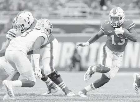  ?? MICHAEL REAVES/GETTY ?? DeeJay Dallas was called on to fill former Hurricanes punt returner Jeff Thomas’ spot on Saturday against Pittsburgh and delivered a 65-yard touchdown.