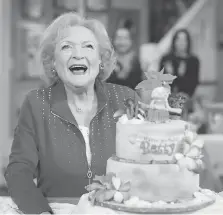  ?? MARK DAVIS/GETTY IMAGES ?? Betty White, seen here celebratin­g her 93rd birthday on the set of Hot in Cleveland, is happy to keep busy working.