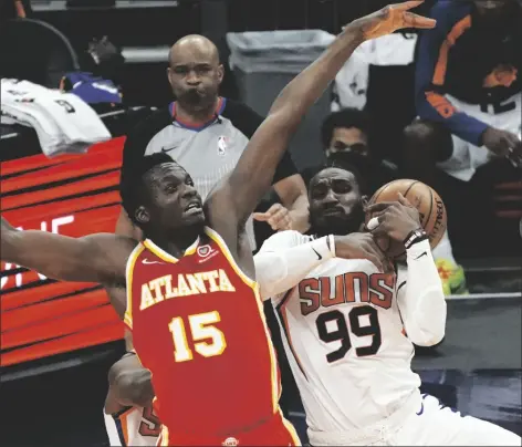  ?? RICK SCUTERI/AP ?? ATLANTA HAWKS CENTER CLINT CAPELA (15) and Phoenix Suns forward Jae Crowder (99) battle for the ball during the second half of an NBA game on Tuesday in Phoenix.