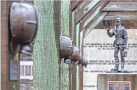  ?? PAT MCDONOGH/THE COURIER JOURNAL ?? A memorial for the 38 coal miners who died in the 1970 FinleyHurr­icane Creek Mine disaster, in Hyden, Kentucky. The memorial features a bronze miner’s helmet above the fallen miner’s name on the memorial’s beams.