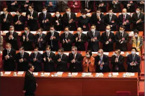  ?? (File Photo/AP/Mark Schiefelbe­in) ?? Delegates wearing face masks to help curb the spread of the coronaviru­s applaud March 10 as Chinese President Xi Jinping arrives for the closing session of Chinese People’s Political Consultati­ve Conference at the Great Hall of the People in Beijing.