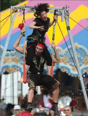  ?? MATHEW MCCARTHY, RECORD , RECORD STAFF ?? Noa and Uri Weiss, of Cirque No Problem, perform during the Waterloo Buskers Carnival behind city hall, where business was brisk — compared to across King Street.