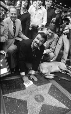  ?? FILE — THE ASSOCIATED PRESS ?? In this file photo, actor Burt Reynolds polishes star that was unveiled in the Hollywood Walk of Fame in Los Angeles.