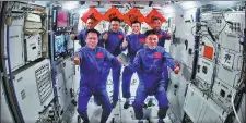  ?? XU BU / FOR CHINA DAILY ?? The three astronauts from China’s Shenzhou XVIII mission enter the country’s space station and meet with the astronauts from the Shenzhou XVII mission on Friday. The two groups of astronauts will conduct an in-orbit rotation at the space station.