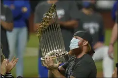  ?? THE ASSOCIATED PRESS ?? In this Tuesday, Oct. 27, 2020, file photo, Los Angeles Dodgers third baseman Justin Turner celebrates with the trophy after defeating the Tampa Bay Rays 3-1to win the baseball World Series in Game 6in Arlington, Texas.