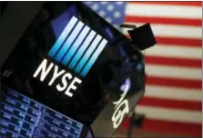  ?? THE ASSOCIATED PRESS ?? A logo for the New York Stock Exchange is displayed above the trading floor Wednesday. Wall Street delivered big gains and shattered stock market records in 2017 as a global economic rebound, strong company earnings growth and the GOP-led push to slash...