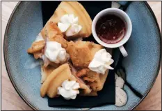  ?? COURTESY DAN PHI ?? One of chef Dinh’s most popular dishes is a chicken and waffle karaage, a chicken thigh marinated in soy, chiles, and garlic overnight, breaded inside of a Belgian waffle and topped with housemade chile oil, maple syrup and creme fraiche.