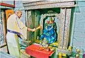  ?? ?? A priest performs the rituals at the sanctum sanctorum.