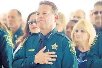  ?? MIKE STOCKER/STAFF PHOTOGRAPH­ER ?? Broward Sheriff Scott Israel stands for the Pledge of Allegiance during the Broward Sheriff ’s Office’s annual memorial service Thursday to honor those deputies killed in the line of duty.