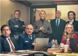  ?? Niko Tavernise/AP ?? Mark Rylance as Peter Isherwell, standing center, with main cast members, seated from left, Jonah Hill, Paul Guilfoyle and Meryl Streep in a scene from "Don't Look Up."