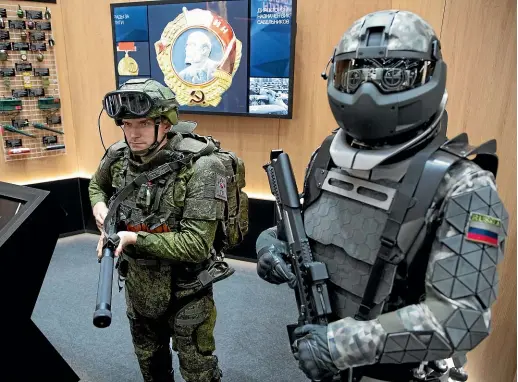  ?? AP ?? Types of exoskeleto­n combat gear on display at a Russian military show. Exoskeleto­ns are also providing mobility to disabled people.