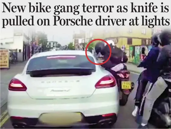  ??  ?? Give us your watch! Four yobs on two mopeds threaten the terrified Porsche driver with a knife, circled, in the evening rush hour