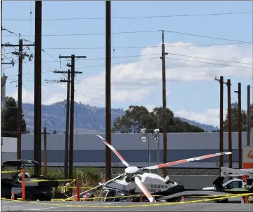  ?? PHOTOS BY DOUG DURAN — STAFF PHOTOGRAPH­ER ?? A Pacific Gas & Electric helicopter crashed at a training facility on National Drive in Livermore on Wednesday. Two men were injured in the crash and are expected to survive, according to the Livermore Police Department.