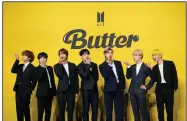  ?? (AP/Lee Jin-man) ?? A May photo shows members of South Korean K-pop band BTS posing for photograph­ers ahead of a news conference to introduce their new single “Butter” in Seoul.